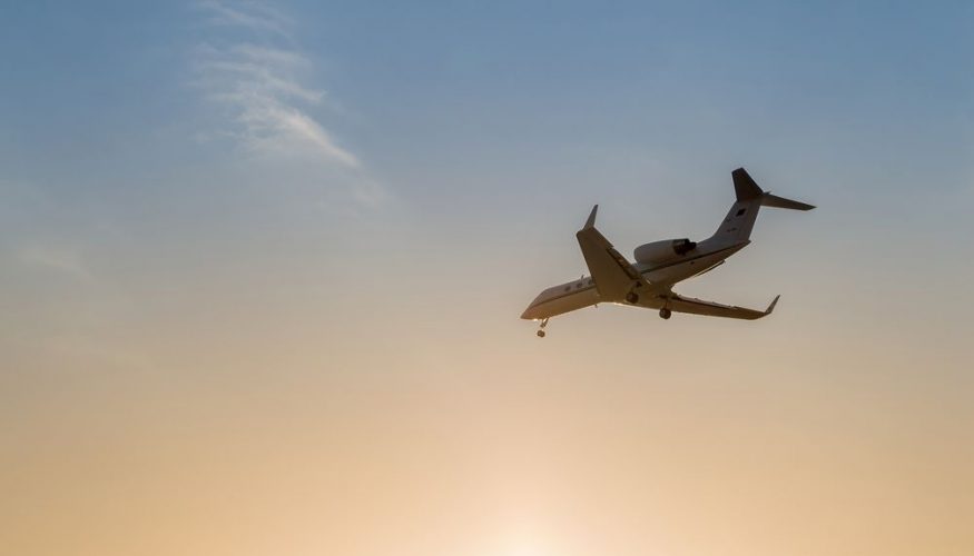 airplane in the sky at sunset