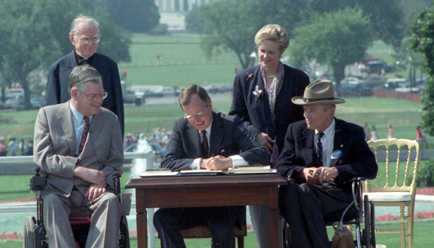 A photo of the original signing of the Americans with Disabilities Act