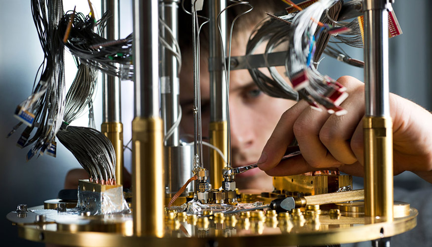 A professional works on the dilution refrigerator system that cools the processors in the company’s quantum computer