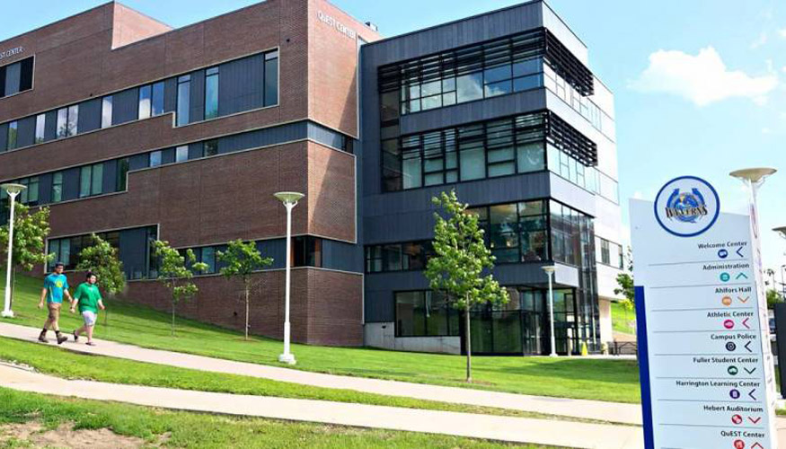 Quinsigamond campus with two students walking on path