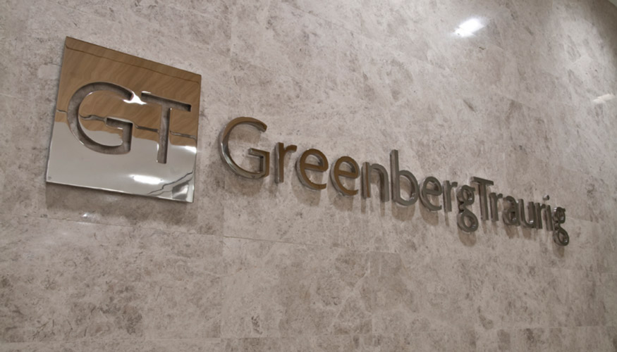 Greenberg Traurig logo on marble wall