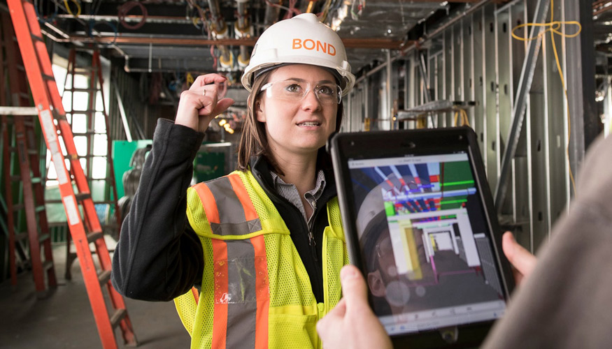 woman in hard hat and vest at construction site