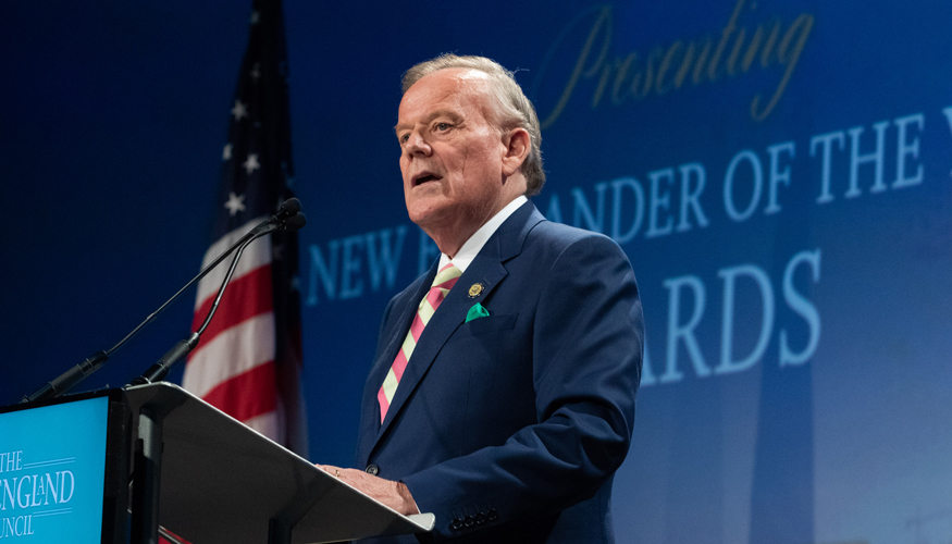 Jim Brett giving a speech at a podium