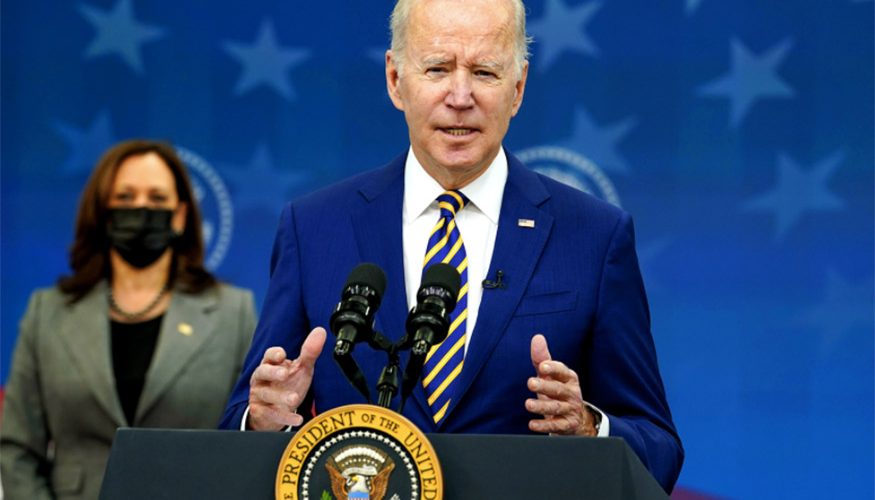 President Joe Biden speaking at podium