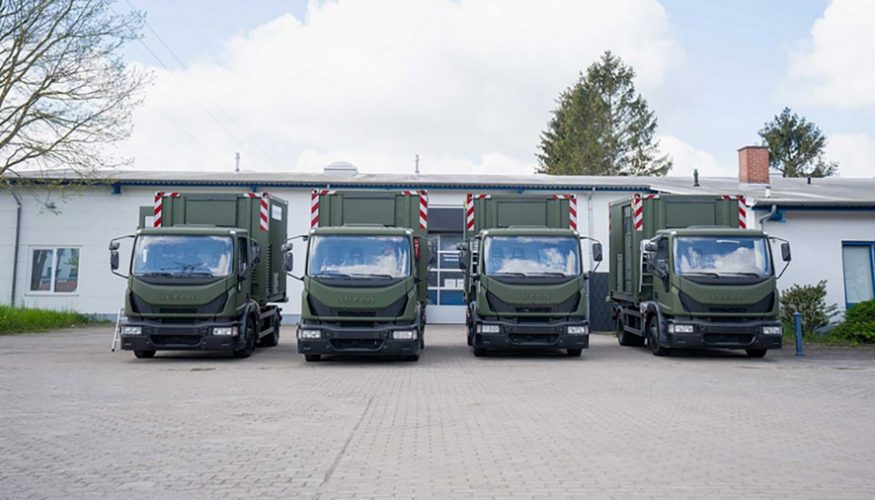 4 green trucks lined up side by side