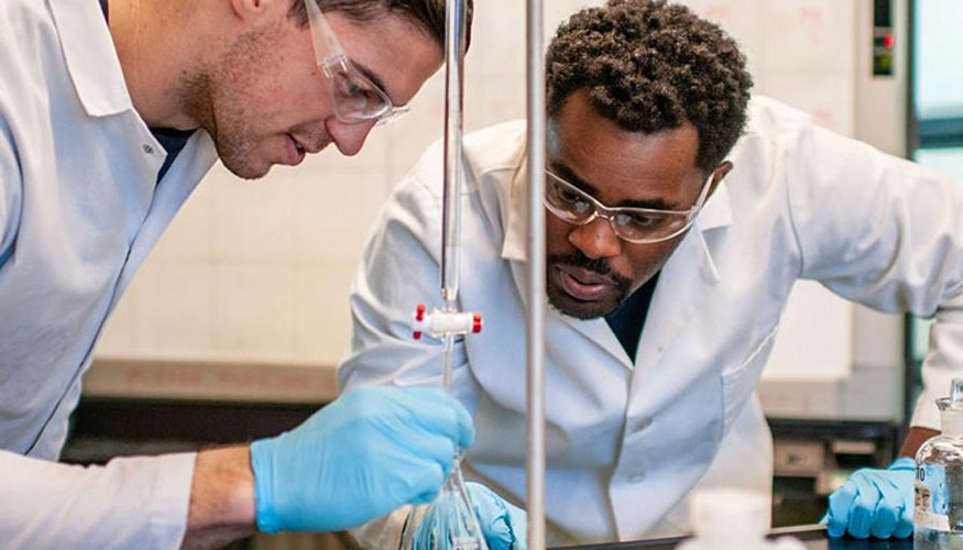 Two diverse men working together in a lab