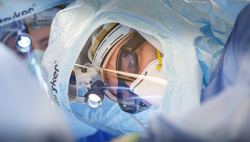 John-Erik Bell, MD is pictured during surgery wearing NextAR Smart Glasses to visualize surgical actions and information in real-time, directly on the operative field.